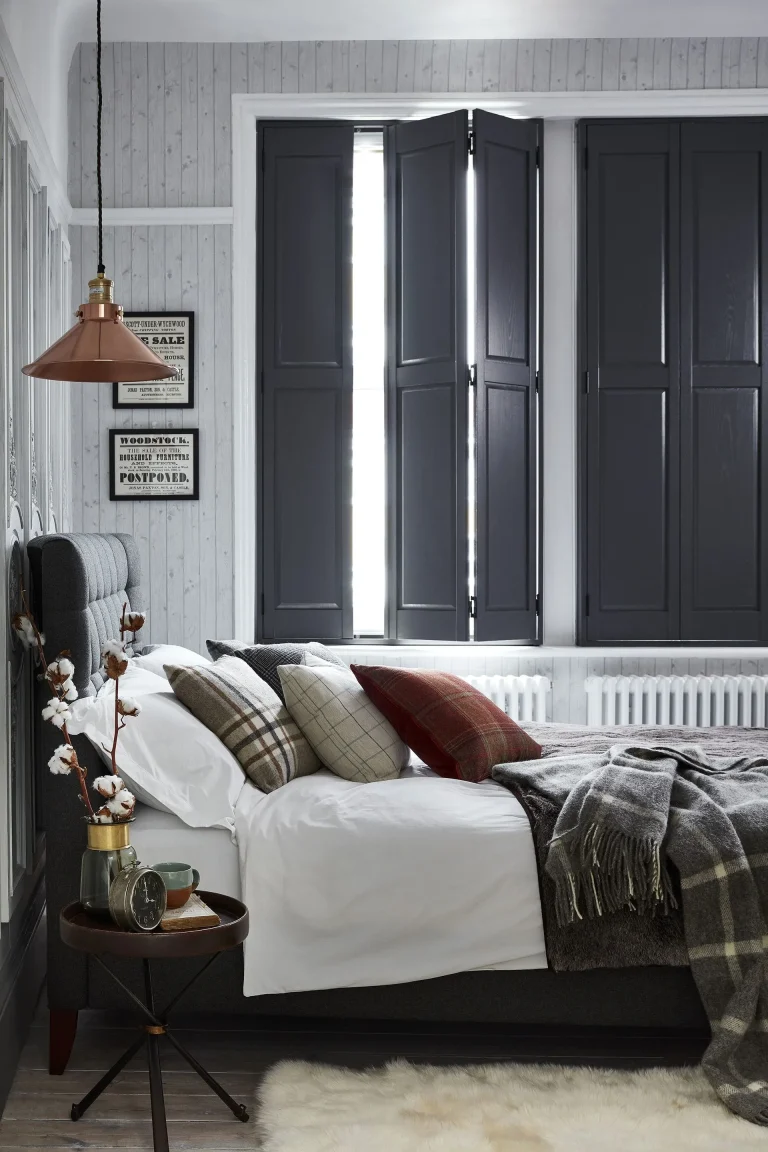 Dark grey solid shutters in a cozy bedroom