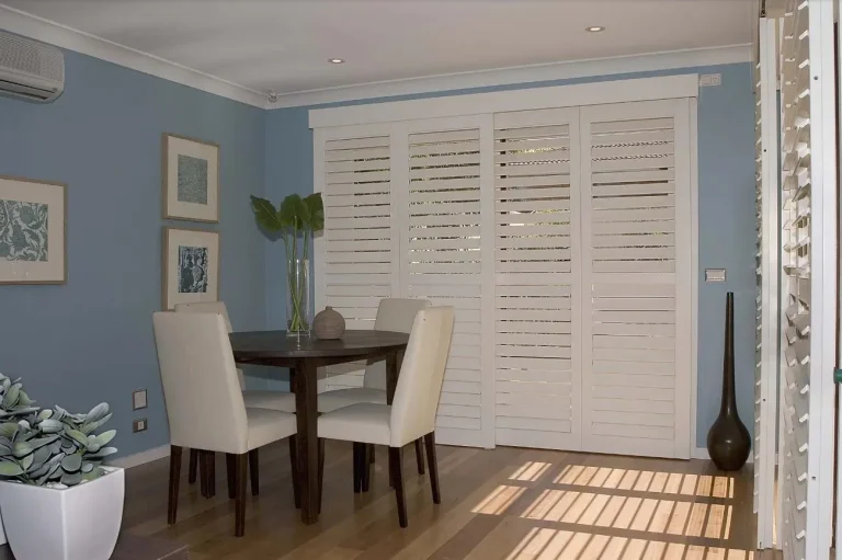 White track shutters in a dining room