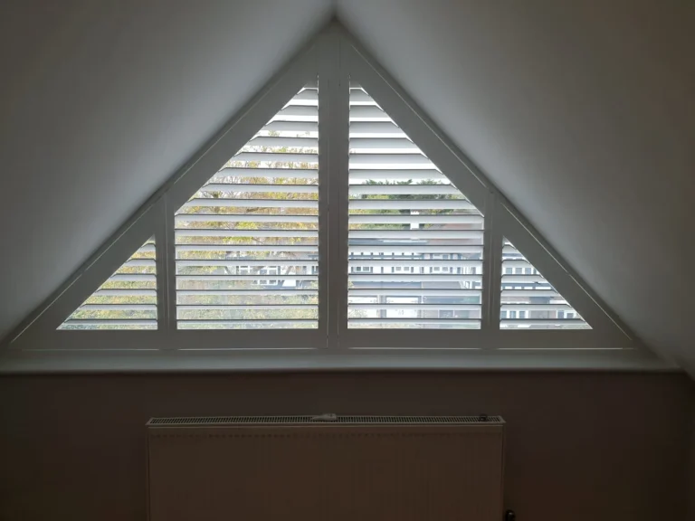 Triangular special shape shutters in an attic window