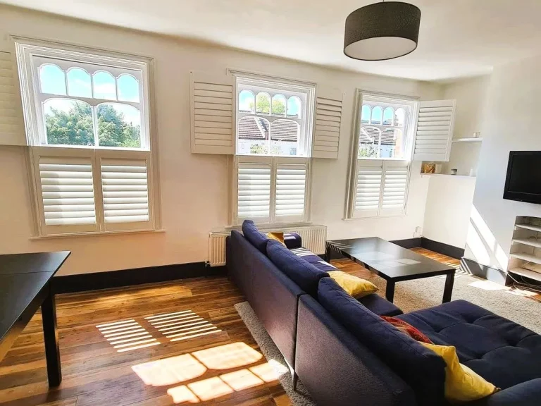 White tier on tier shutters in a bright living room