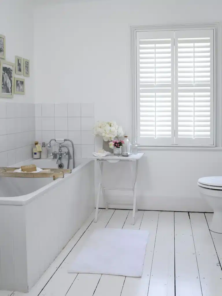 White full height shutters in a classic bathroom