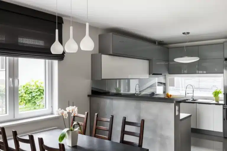 Black Roman blinds in a modern kitchen-dining area