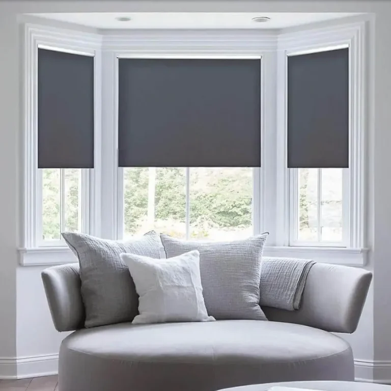 Stylish grey roller blinds in a modern living room