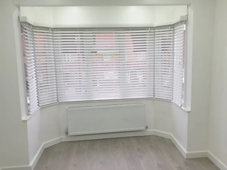 White venetian blinds in a bay window