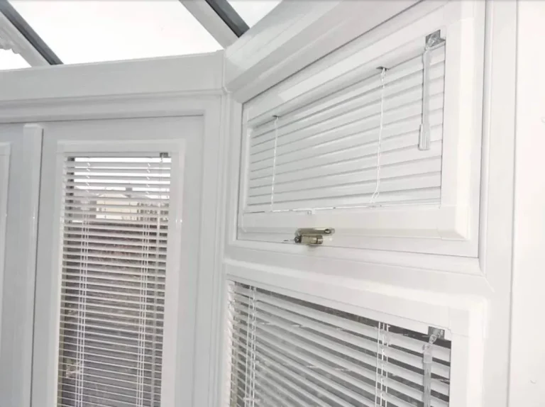 White perfect fit venetian blinds in a conservatory