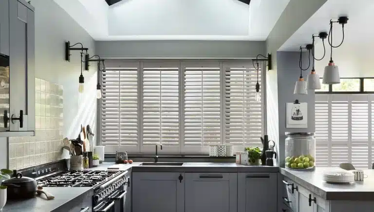 Home window shutters in a bright kitchen setting with a classic design