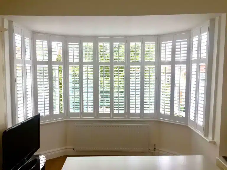 Energy-saving window shutters installed in a stylish living room with a modern aesthetic.