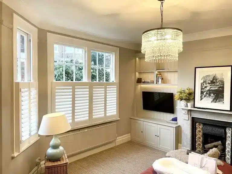 Child-safe window shutters in a modern North London living room with neutral decor.