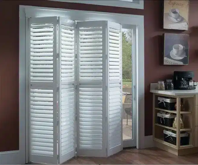 Custom blinds and shutters installed on patio doors in a modern home