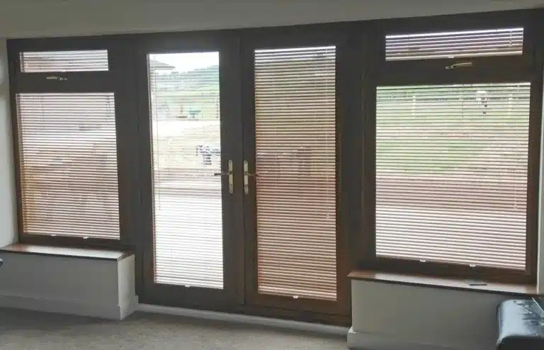 Brown plantation shutters installed on large windows and doors, enhancing the room's aesthetic appeal.