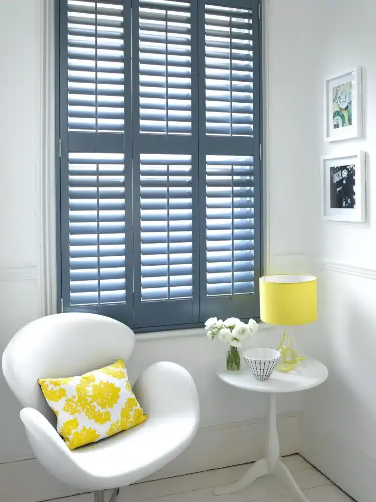 Track system shutters in a modern living room setting with grey dual-layer blinds