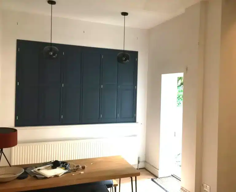 Modern dining area featuring handcrafted plantation shutters from North London Shutters and Blinds.