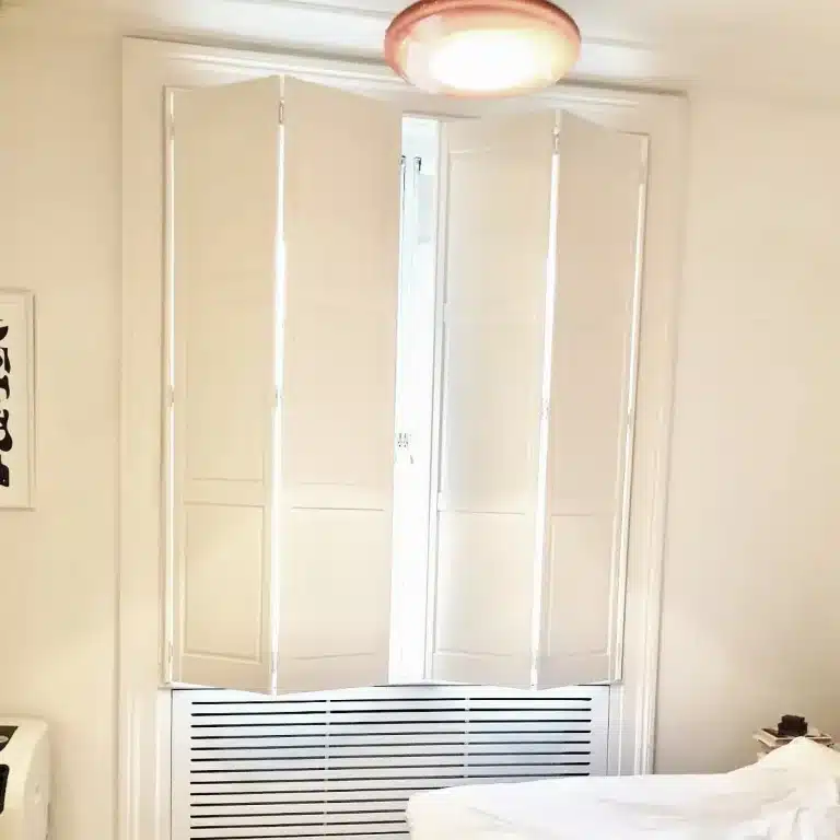 White wooden blinds and shutters providing privacy and style to a North London home.