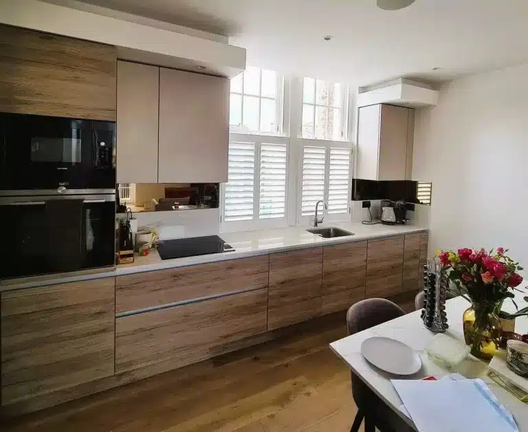 Contemporary kitchen featuring North London Shutters and Blinds' handcrafted window shutters.