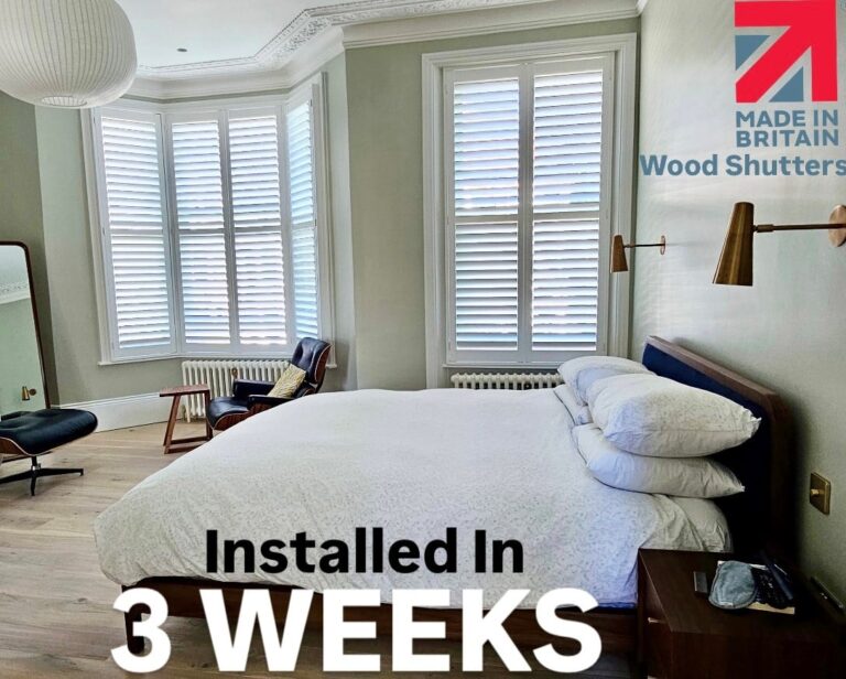 Beautiful white wooden inside shutters installed in a modern bedroom with bay windows, providing light control and privacy in a London home