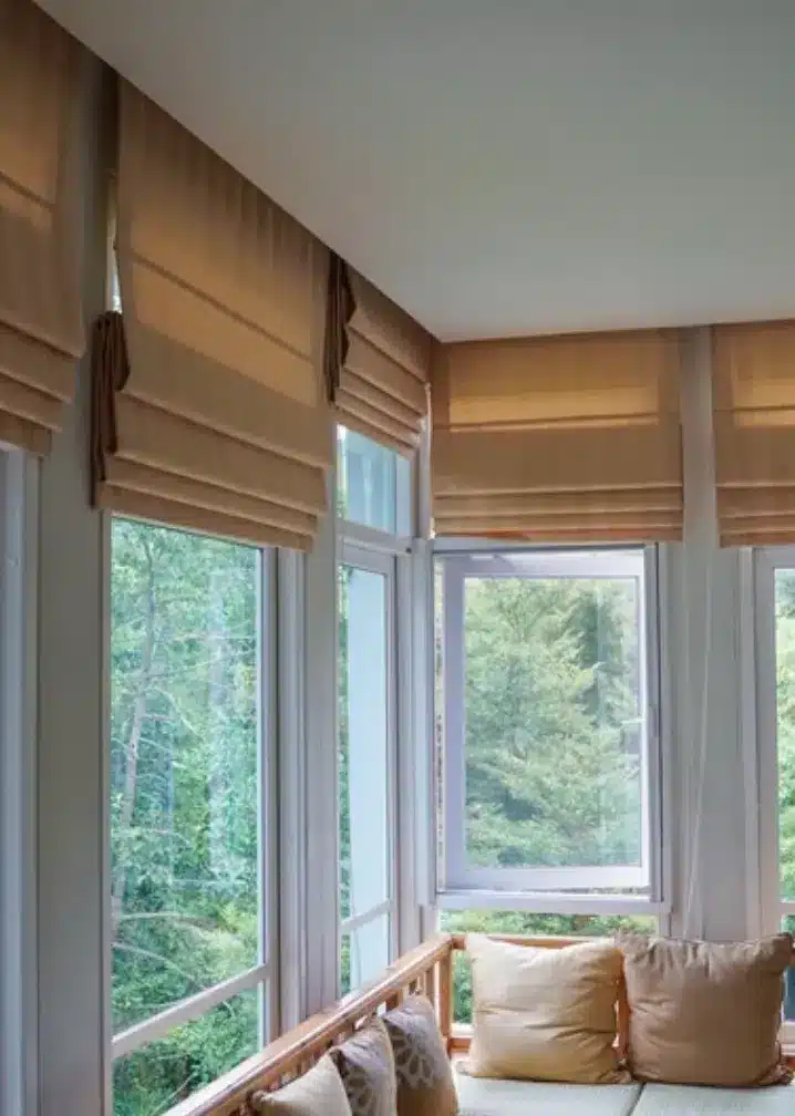 wooden window shutters internal Roman blinds bay window seat North London home interior
