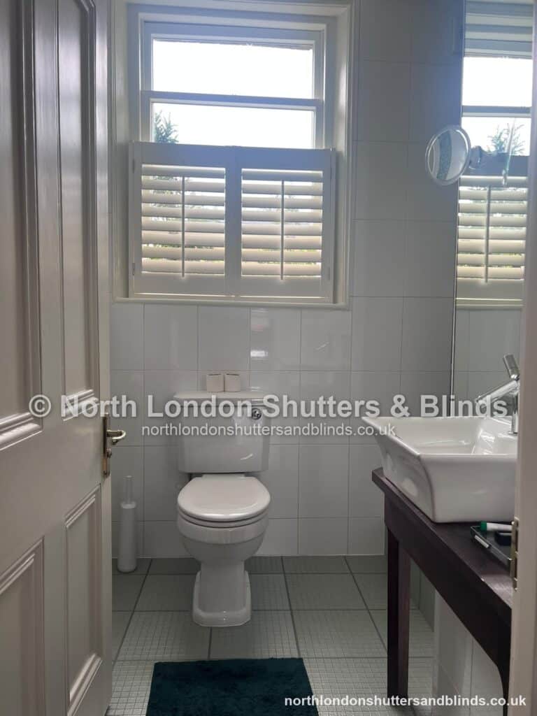 White café style plantation shutters in a bathroom by shutter fitters in Barnet, North London