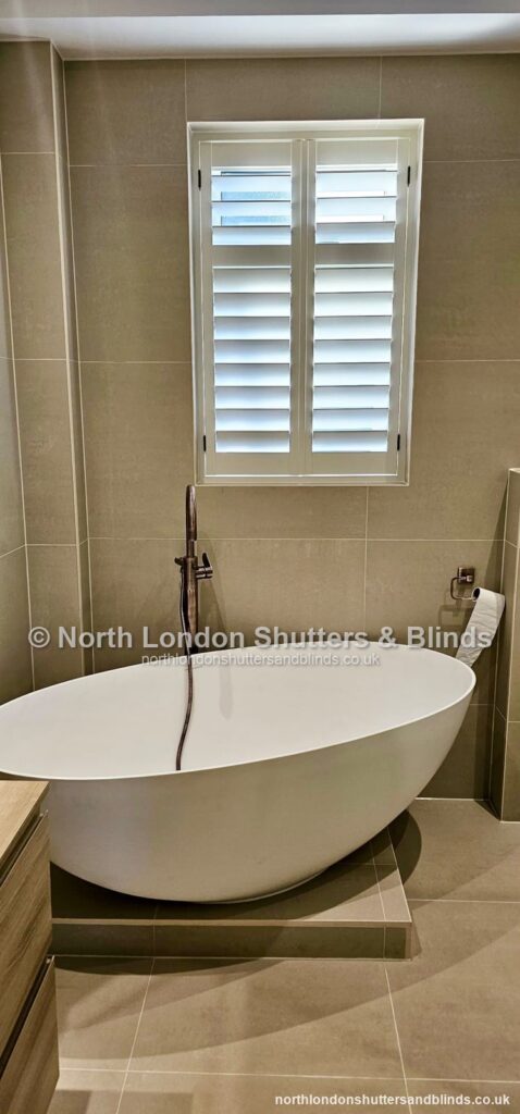 White full height plantation shutters in a bathroom by shutter fitters in Barnet, North London