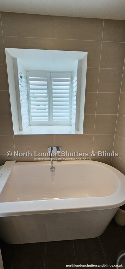 White full height plantation shutters in a bathroom by shutter fitters in Barnet, North London