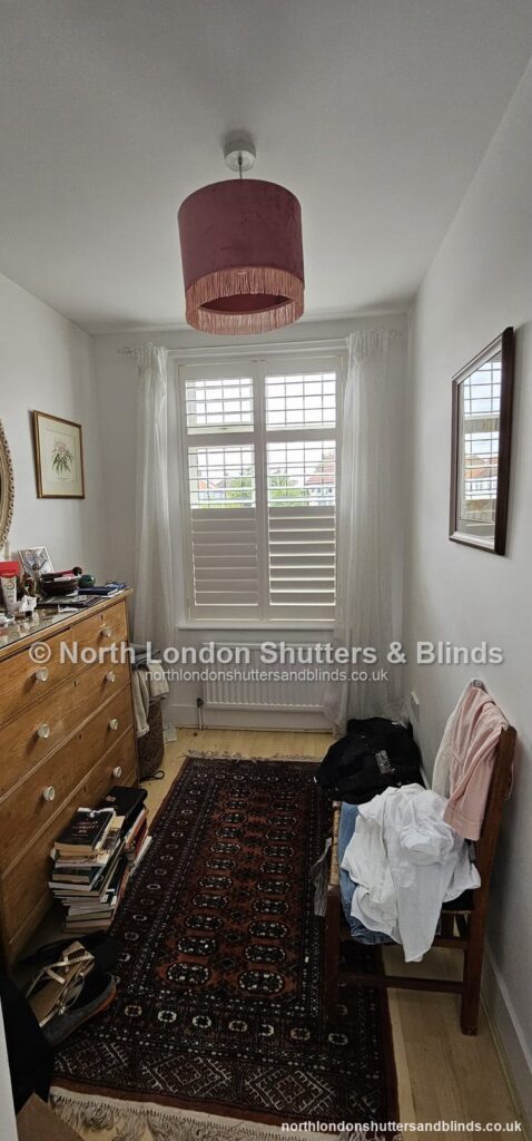 White café style plantation shutters in a bedroom by shutter fitters in Barnet, North London
