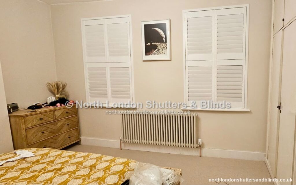 White full height plantation shutters in a bedroom by shutter fitters in Barnet, North London