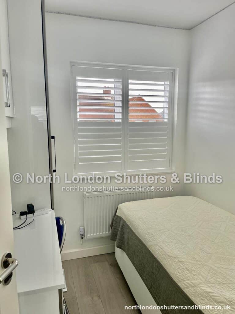 White full height plantation shutters in a bedroom by shutter fitters in Barnet, North London