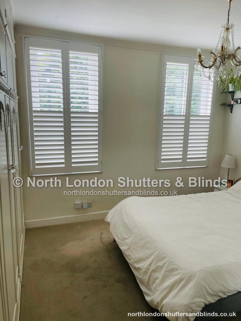 White full height plantation shutters in a bedroom by shutter fitters in Barnet, North London