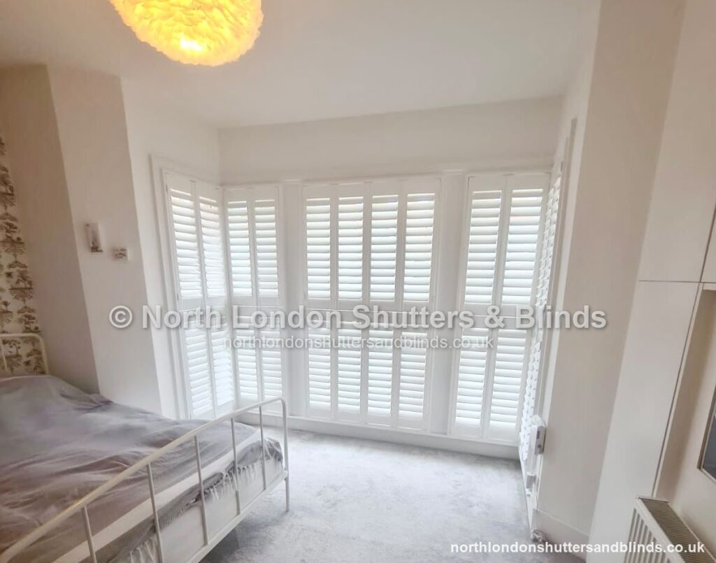 White full height plantation shutters in a bedroom by shutter fitters in Barnet, North London