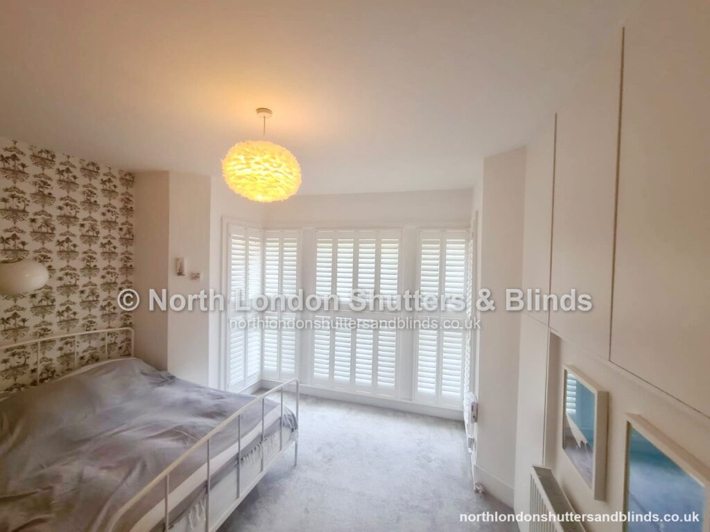 White full height plantation shutters in a bedroom by shutter fitters in Barnet, North London