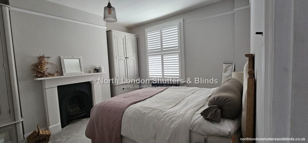 White full height plantation shutters in a bedroom by shutter fitters in Barnet, North London