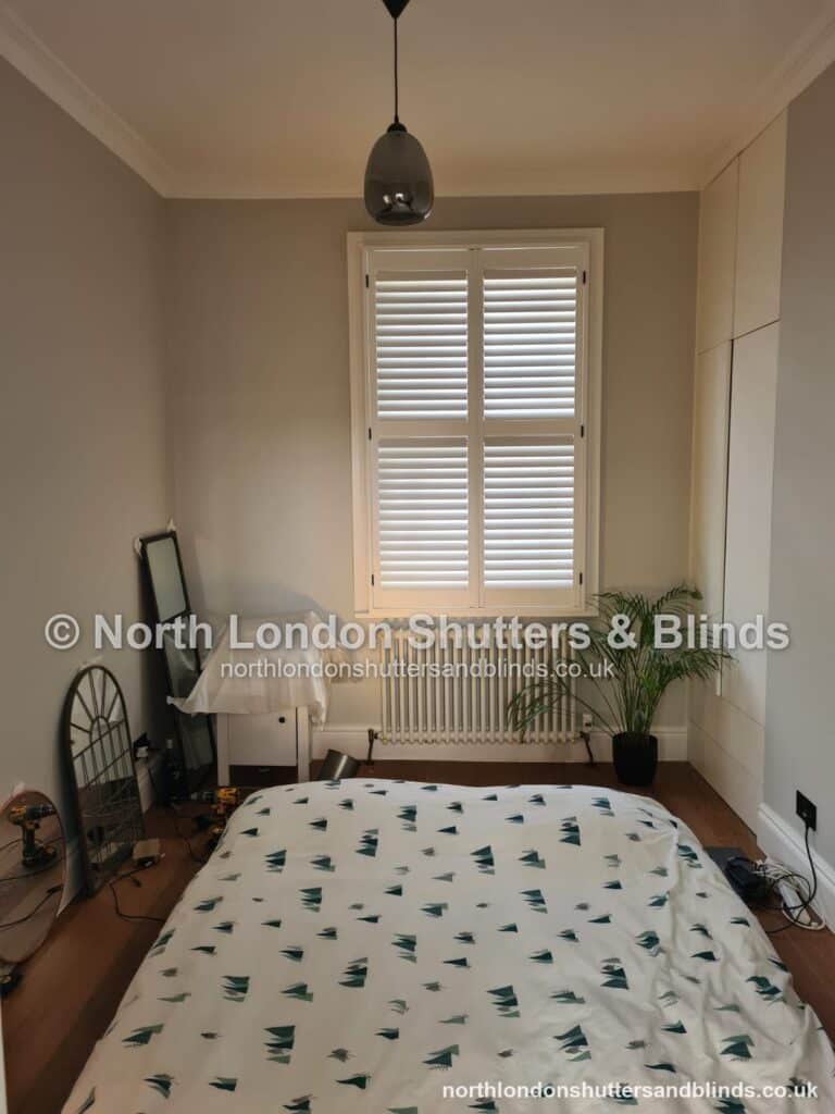 White full height plantation shutters in a bedroom by shutter fitters in Barnet, North London