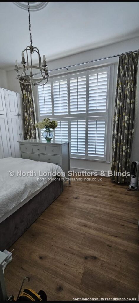 White full height plantation shutters in a bedroom by shutter fitters in Barnet, North London