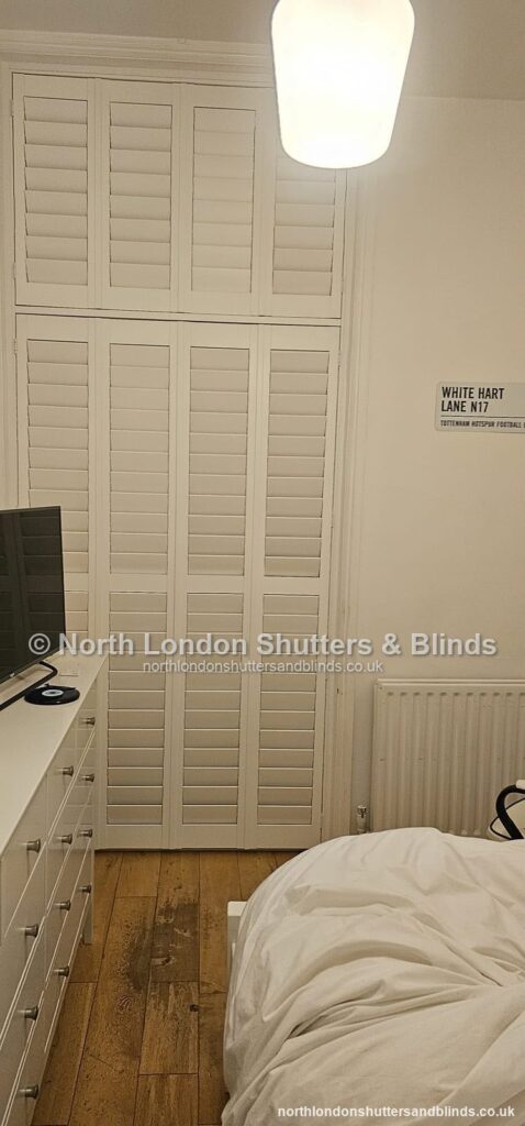 White full height plantation shutters in a bedroom by shutter fitters in Barnet, North London