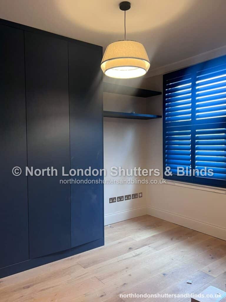 Royal blue full height plantation shutters in a bedroom by shutter fitters in Barnet, North London
