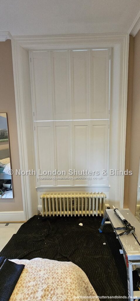 White solid panel shutters in a bedroom by shutter fitters in Barnet, North London