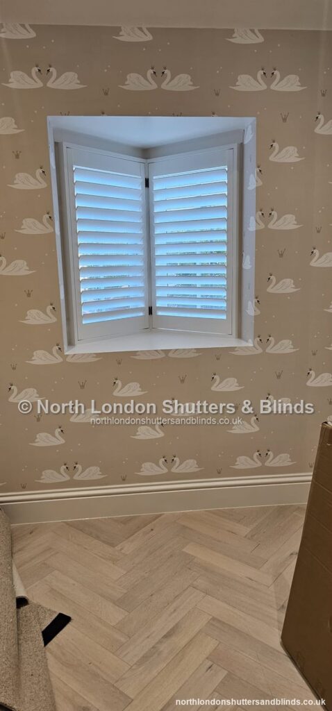 White full height plantation shutters on a small window in a children's bedroom by shutter fitters in Barnet, North London