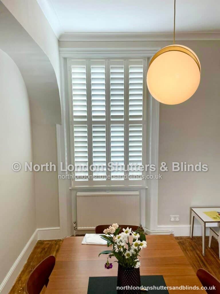 White full height plantation shutters in a dining room by shutter fitters in Barnet, North London