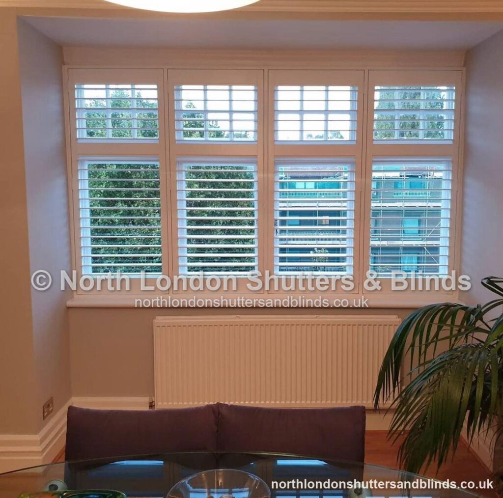 White tier-on-tier plantation shutters in a dining room by shutter fitters in Barnet, North London
