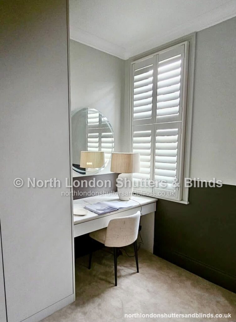 White full height plantation shutters in a dressing room by shutter fitters in Barnet, North London