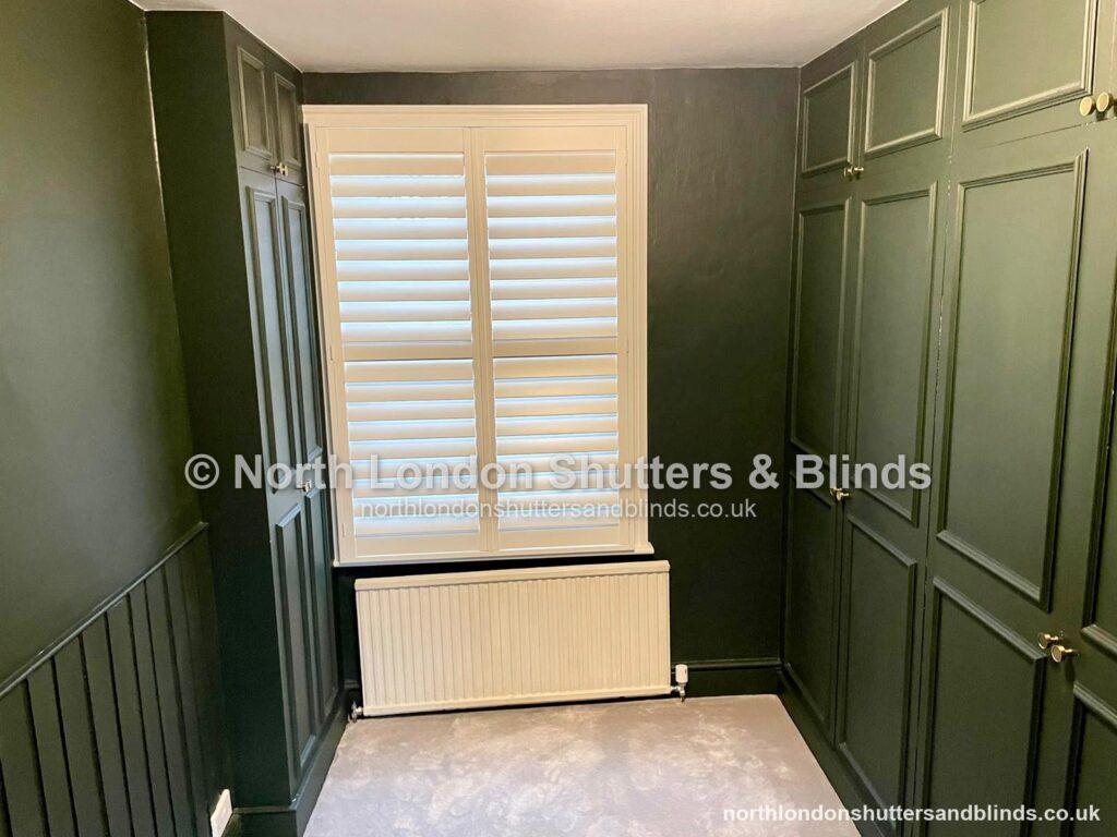 White full height plantation shutters in a dressing room by shutter fitters in Barnet, North London