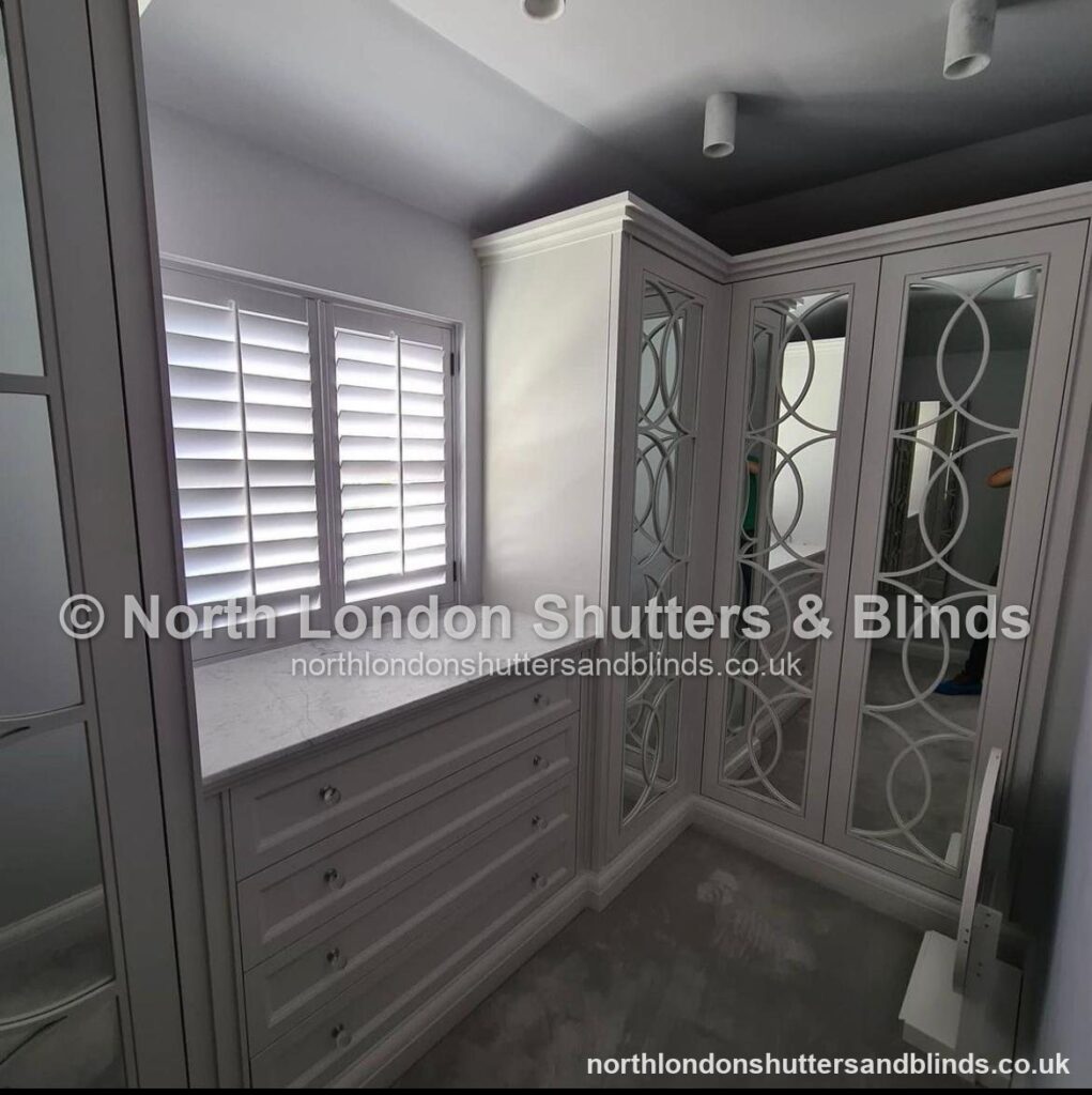 White full height plantation shutters in a dressing room by shutter fitters in Barnet, North London