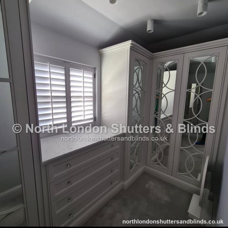 White full height plantation shutters in a dressing room by shutter fitters in Barnet, North London