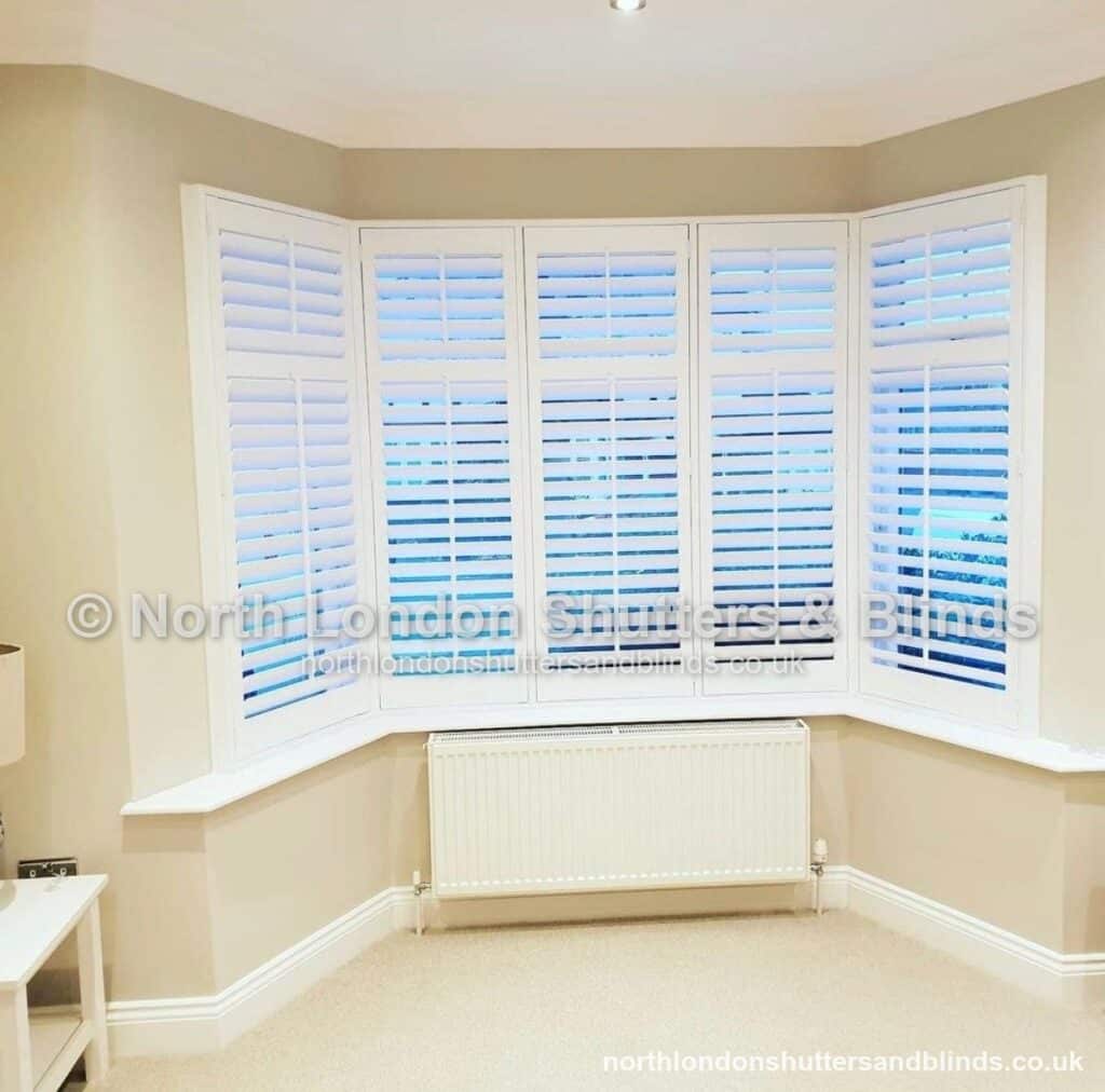 White full height plantation shutters on a bay window by shutter fitters in Barnet, North London