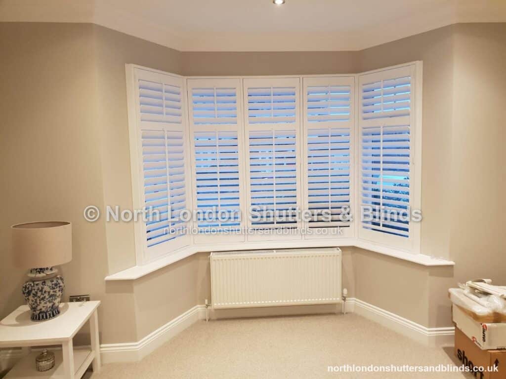 White full height plantation shutters on a bay window by shutter fitters in Barnet, North London
