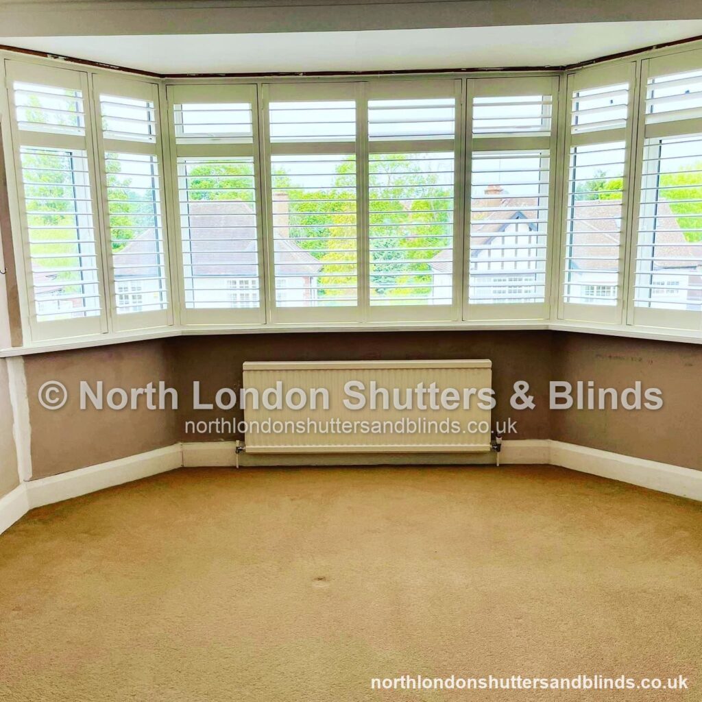 White full height plantation shutters on a wide bay window by shutter fitters in Barnet, North London