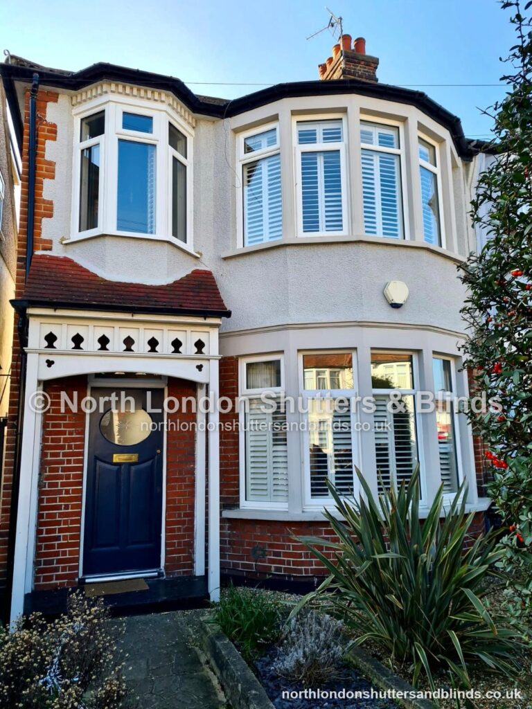 White full height plantation shutters on a bay window on a North London house by shutter fitters in Barnet, North London