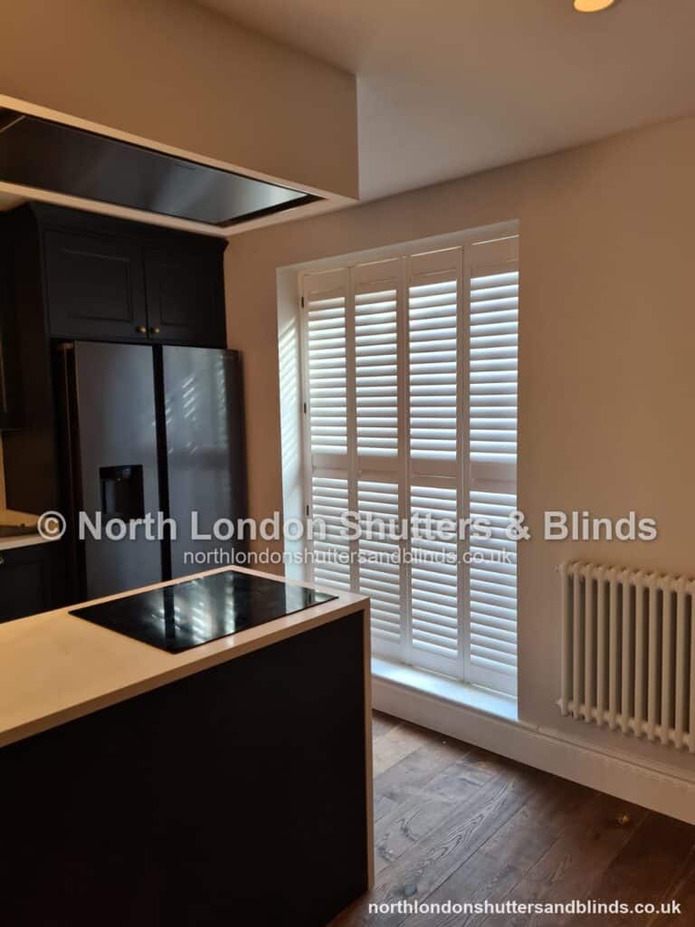 White full height plantation shutters on a door in a kitchen by shutter fitters in Barnet, North London