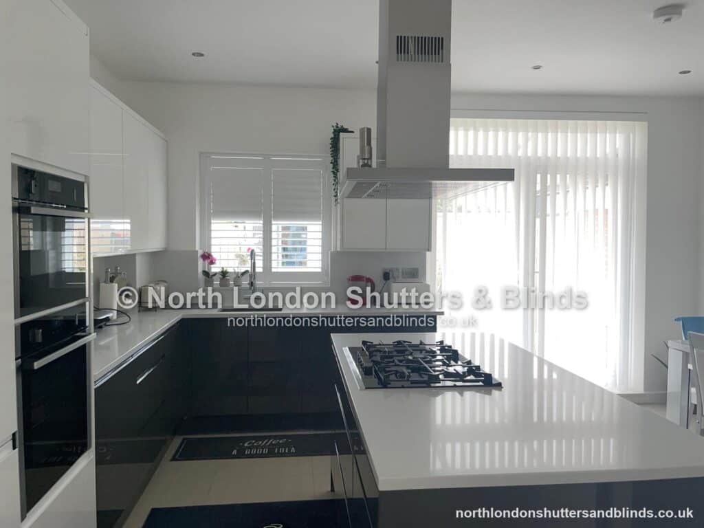 White full height plantation shutters on a modern window in a kitchen by shutter fitters in Barnet, North London