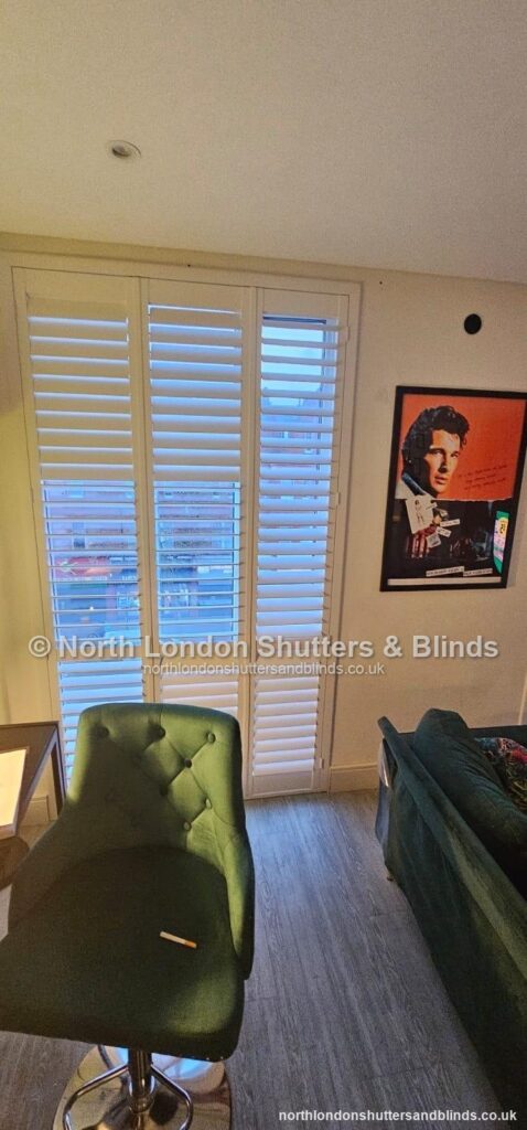White full height plantation shutters on a patio door in a living room by shutter fitters in Barnet, North London