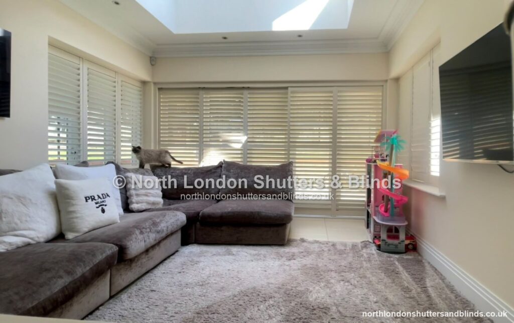White full height plantation shutters on patio doors in a living room by shutter fitters in Barnet, North London